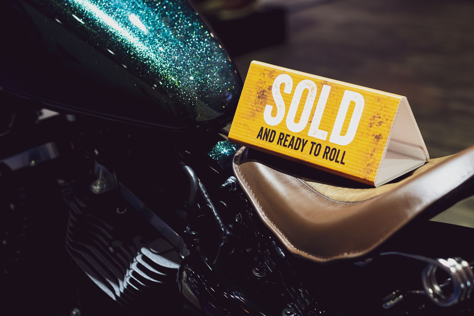 Close up of Sign "Sold and Ready to Roll" on motorcycle